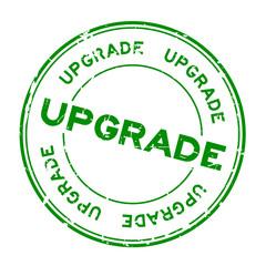 Grunge green upgrade wording round rubber seal stamp on white background
