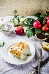 Autumn traditional baked pastry, Sweet homemade apple pie with fresh apples on light linen cloth background, copy space