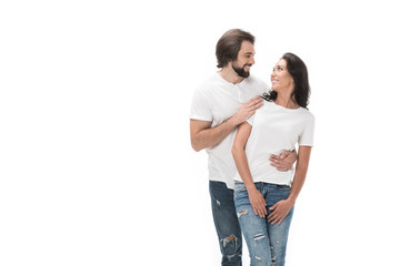 Fototapeta premium portrait of smiling couple looking at each other isolated on white