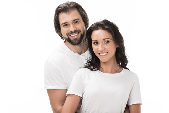 portrait of smiling couple looking at camera isolated on white