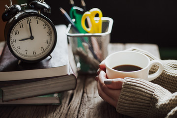 Close up of woman's hands holding a coffee mug, vintage color tone