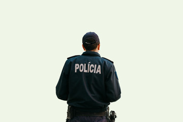 Isolated on white background a policeman is standing with his back in special clothes with the...