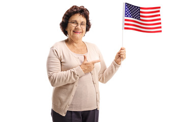 Elderly woman holding an American flag and pointing