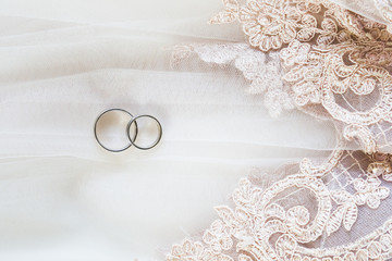 Wedding rings on lace veil