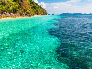 Wonderful seascape. Clear turquoise sea, forest mountain and sky.