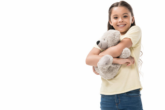 portrait of cute smiling kid hugging teddy bear isolated on white