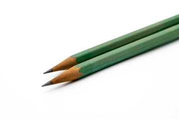 Close up on two green pencils on white background.