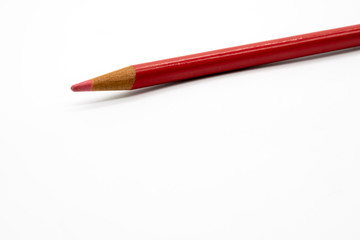 Light red or pink color pencil isolated on white background.
