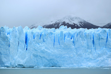 Breathtaking huge ice blue wall of Perito Moreno Glacier in the Los Glaciares National Park, El...