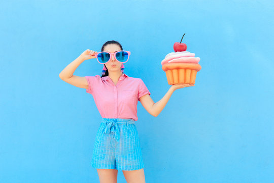 Funny Party Girl with Big Sunglasses and Huge Cupcake 