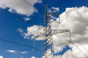 Power pylons and high-voltage lines against the background of the cloudy sky, power lines.