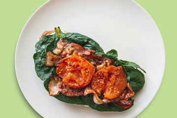 Delicious and nutritious toast or sandwich with bacon, spinach and tomatoes. Tasty food