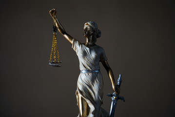 Themis with scales in lawyers office.  Statue of blind goddess 