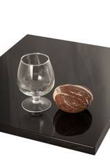 Natural stone and a glass on the varnished coating, the reflection of objects.