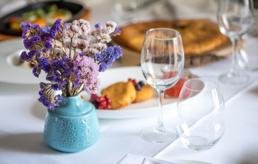 Beautiful flowers in vase with light from window