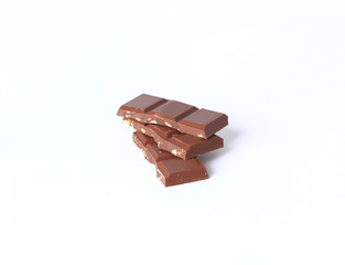 stack pieces of chocolate with nuts isolated on white