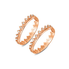A pair of luxury rose gold rings with diamonds on the white background, isolated, golden rings isolated