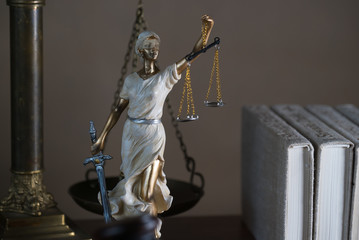 Themis with scales in lawyers office.  Statue of blind goddess 