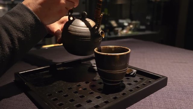 pouring sake in the cup. Japanese tradition