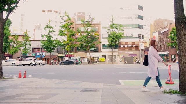 Full video HD Travel and relax concept from beauty asian woman in warm suit walking on street with modern city background