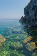 Bright clear aqua green water on Bruce Peninsula with big limestone rocks