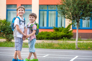 Young students, two sibling brothers, going to school.