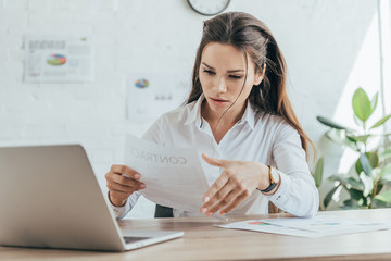 businesswoman working in hot office with documents and laptop