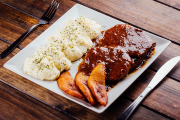 Asado negro with mashed potatoes and fried plantain