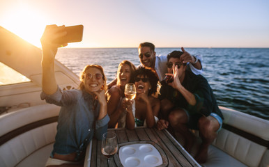 Friends posing for a selfie at boat party