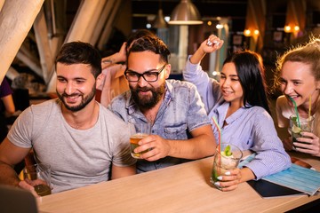 Friends drink alcoholic drinks in the night bar