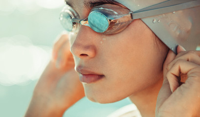 Professional swimming athlete in cap and goggles