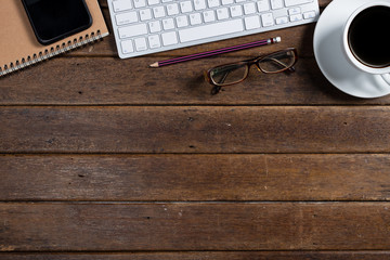 Modern dark wooden office desk table with computer and smartphone cup of coffee. Hero Header Concept with Copy space.