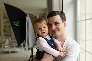 Obraz premium Happy parents playing with child at home