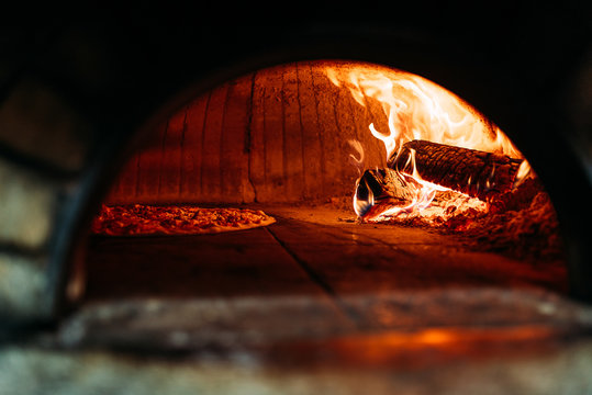 Traditional way baked pizza in a wood fired oven.
