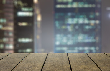 Open space for product on wood with city background.  New item product display with copy space for words.