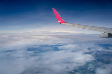 View of airplane wing and blue sky use as travel or background