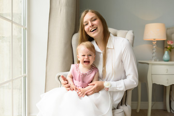 Happy parents playing with child at home