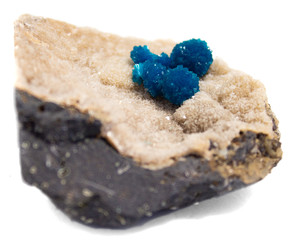 Natural cluster blue cavansite on the substrate on a white background