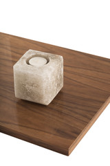 Candlestick made of natural salt on varnished coating, reflection of objects.