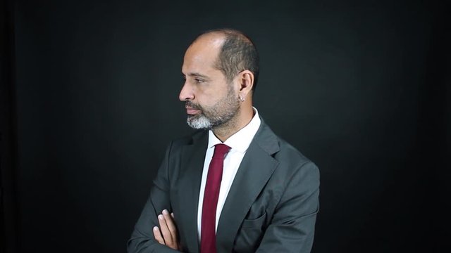 Business man reaction saying no and sorry.  Professional latino mexican saying it cannot happen.  Surprised emotional reaction.