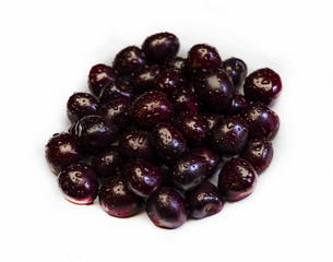 Close-up of a mature sweet cherry. A large collection of fresh red cherries. Ripe cherries on a white background. Isolated. Focus on the center