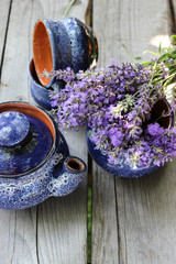 Obraz na płótnie Canvas A bouquet of fresh cut lavender with tableware Gzhel