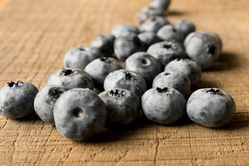 Fresh blueberries on an old wooden table. Close up. The concept of natural food