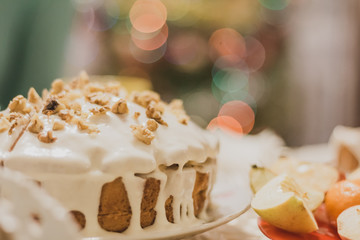 white cake on a background of lights