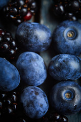fresh blueberries and blackberryes on a dark background