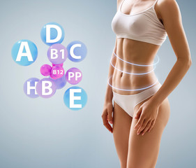 Muscular young woman athlete near minerals and vitamins icons.