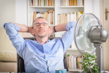 Man suffers from heat in the office or at home