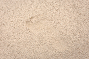 Fototapeta na wymiar soft foot print on yellow soft sand texture a bit rough