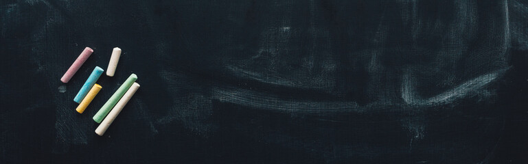 Colorful chalk on blackboard