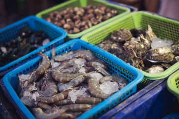 Fresh sea foods with shrimps, shell fish, etc. put in basket ready to cook at restaurant
